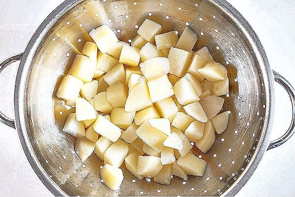 diced potatoes in a silver colander