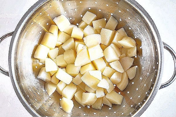 diced potatoes in a silver colander