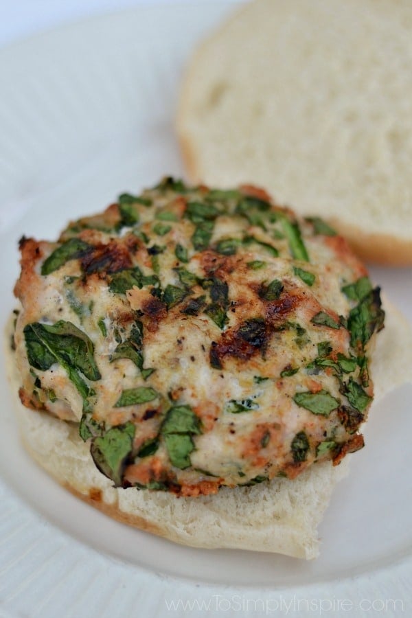 closeup of a spinach turkey burger on a white plate