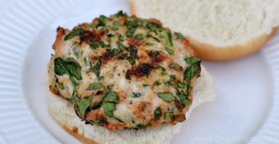 a closeup of a spinach turkey burger on a white plate