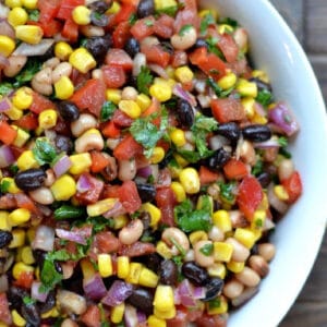 cowboy caviar bean dip in a white bowl