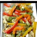 chicken fajitas with orange, yellow and red peppers on a white plate with text overlay