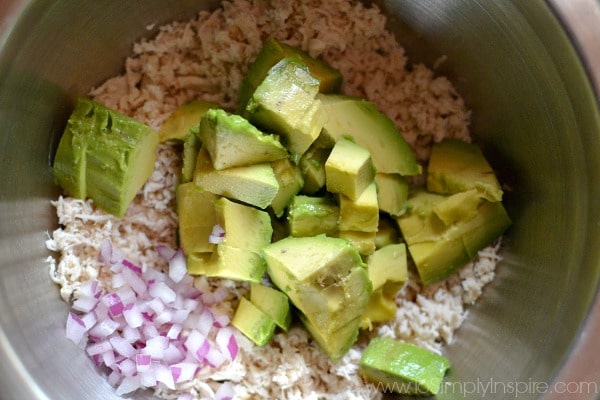 Ingredients for Avocado Chicken Salad in a stainless steel mixing bowl.