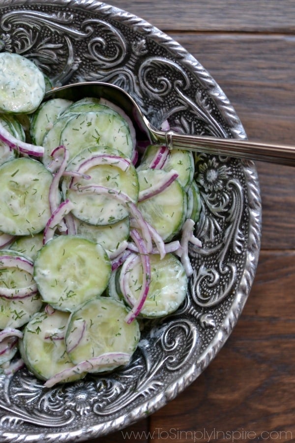 Creamy Cucumber Salad recipe in a big silver bowl with a serving spoon