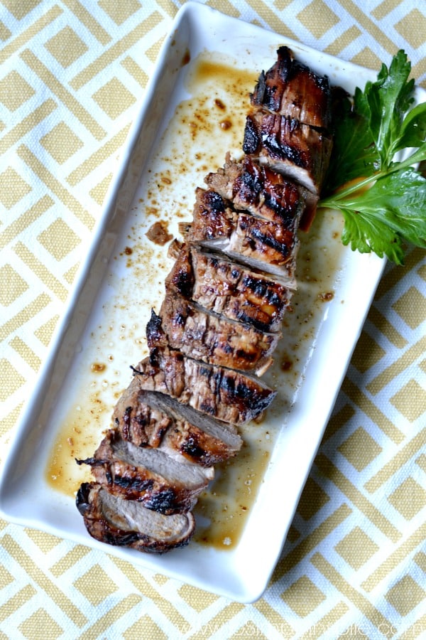 closeup of sliced Honey Dijon Pork Tenderloin recipe on a white rectangle plate