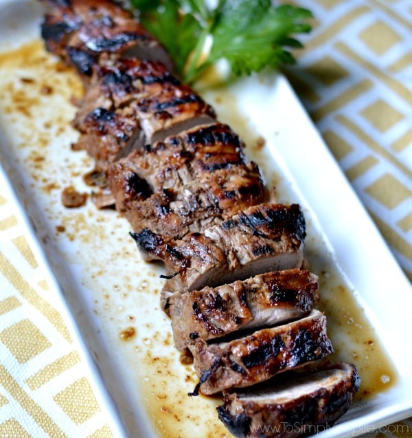 closeup of sliced Honey Dijon Pork Tenderloin recipe on a white rectangle plate