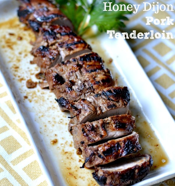 sliced Honey Dijon Pork Tenderloin recipe on a white rectangle plate