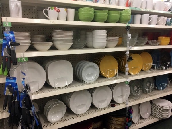 A store shelf filled with dishes and mugs