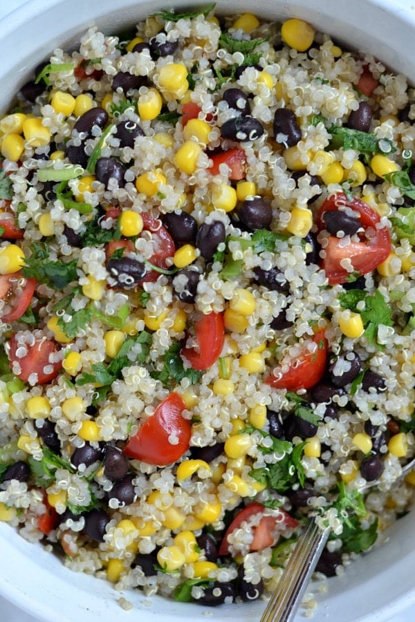 A bowl filled Quinoa salad with black beans, corn and tomatoes