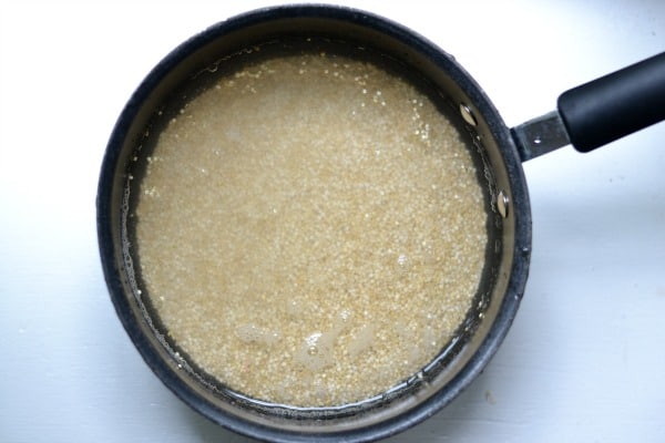 quinoa in a black pot covered in water 