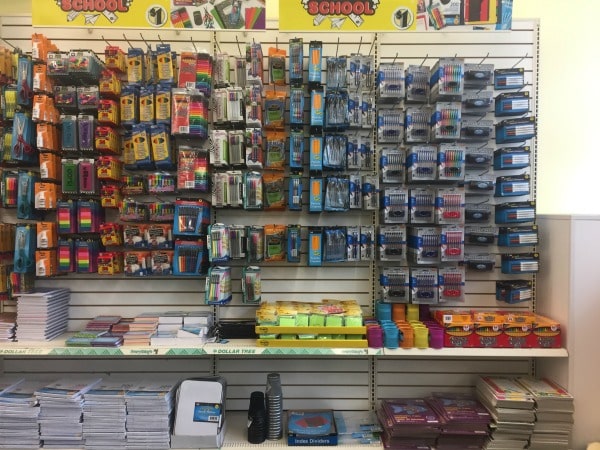 A close up of a store shelf of school supplies