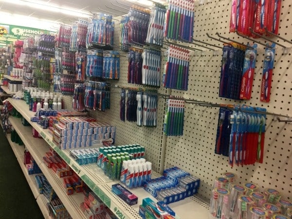 a store shelf display of toothbrushes and toothpaste
