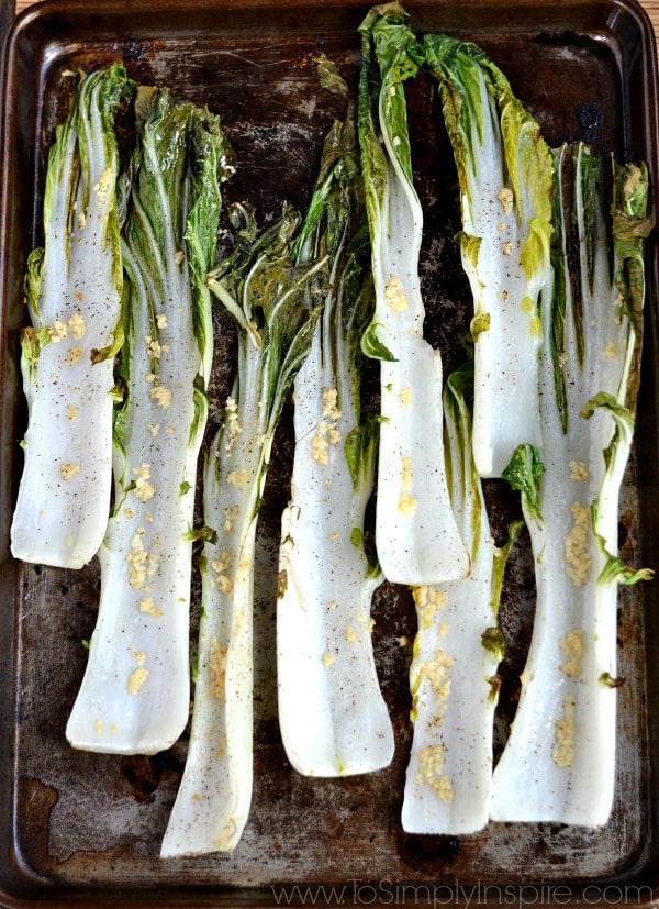 closeup of 8 stalks of Garlic Roasted Bok Choy recipe on a baking sheet