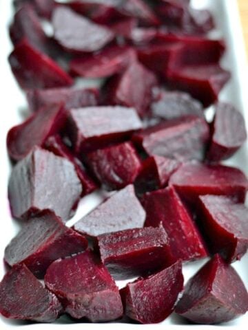 closeup of diced roasted beets on a white plate