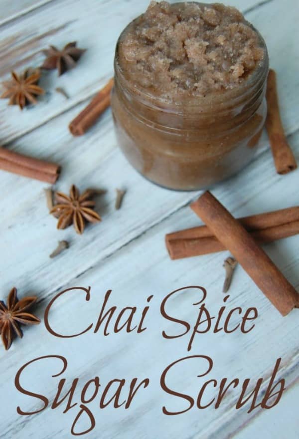 chai spice sugar scrub in a small mason jar with cinnamon sticks around