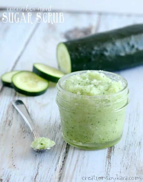 Cucumber mint body scrub in a small mason jar with a cucumber behind