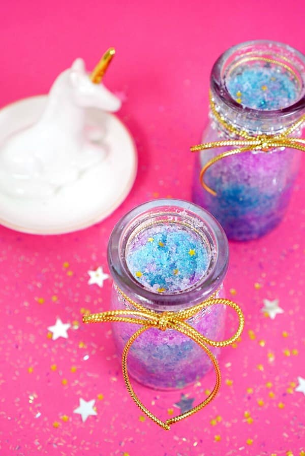 unicorn sugar scrub in glass jar with hot pink background
