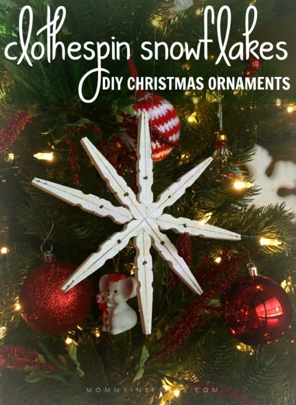 a closeup of a DIY white clothespin Christmas ornament hanging on a tree