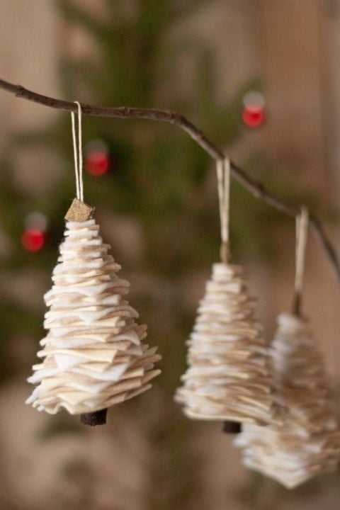three DIY Felt Christmas tree ornaments hanging on a tree