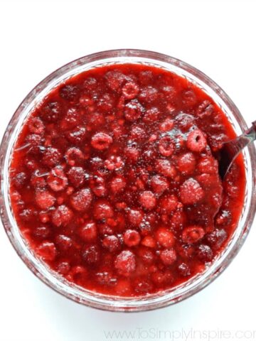 closeup of Raspberry Apple Jello Salad in a bowl with a white background