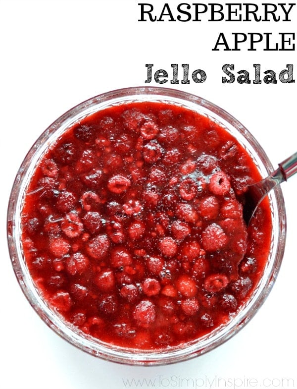 closeup of Raspberry Apple Jello Salad in a bowl with a white background