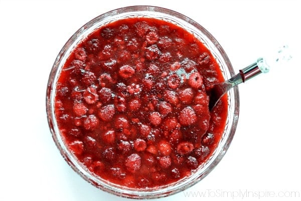 closeup of Raspberry Apple Jello Salad in a bowl with a white background