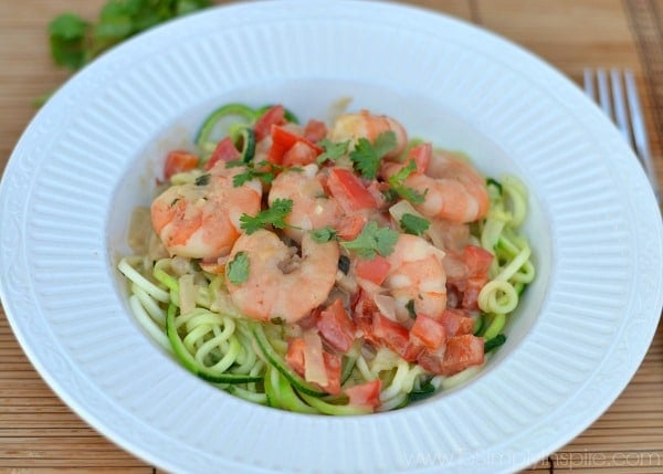 Shrimp on top of Zucchini noodles with red bell peppers and cilantro on top