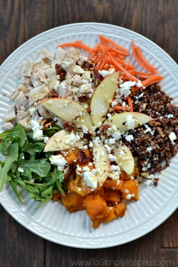 Quinoa Power Bowl withSweet potatoes, arugula, diced apple, red quinoa, feta, roasted pecans topped with honey dijon vinaigrette.