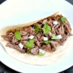 Barbacoa beef recipe in a soft taco shell