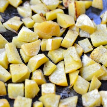 roasted turnips cubes on a baking sheet