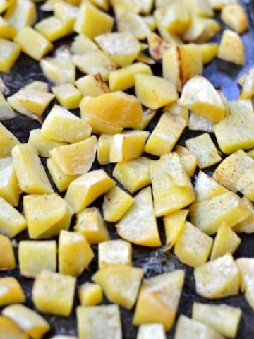 roasted turnips cubes on a baking sheet