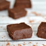 closeup of 2 pieces of healthy chocolate fudge with other pieces in the background