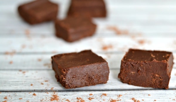 closeup of 2 pieces of healthy chocolate fudge with other pieces in the background