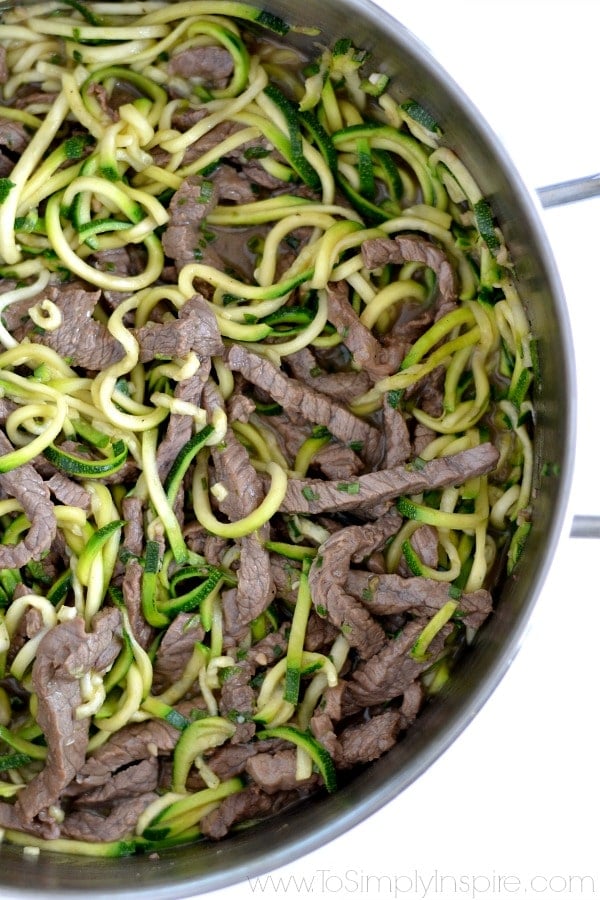 beef strips and teriyaki zucchini noodles in a stainless steel pot