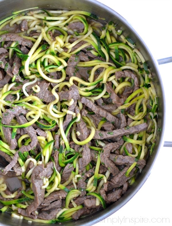 beef strips and teriyaki zucchini noodles in a stainless steel pot