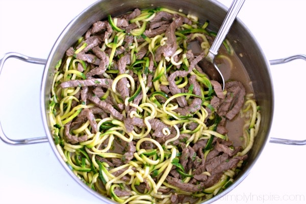 beef strips and teriyaki zucchini noodles in a stainless steel pot