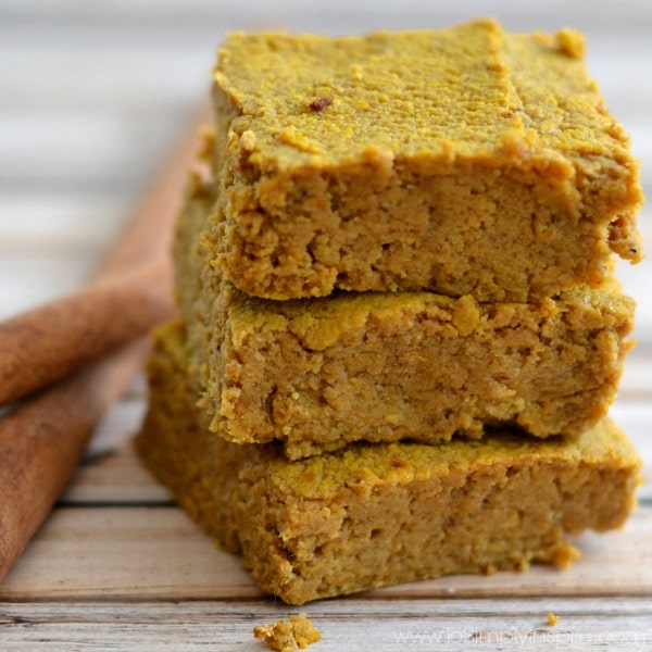 close-up of a stack of three Pumpkin Pie Bars beside 2 cinnamon sticks