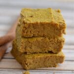 stack of three pumpkin pie bars on a wood table