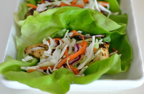 A plate of food with a green salad, with Chicken and Lettuce