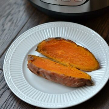 Sweet potato cut open on white plate