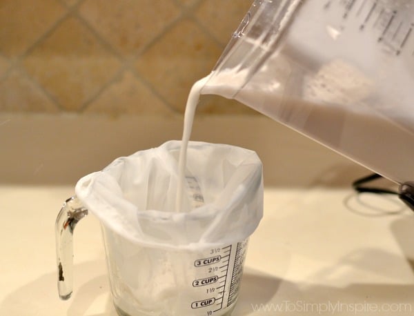 Pouring coconut milk into a nut bag