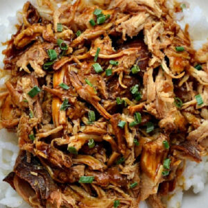 closeup of chicken teriyaki over a bowl of rice