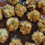 closeup of teriyaki meatballs in brown sauce