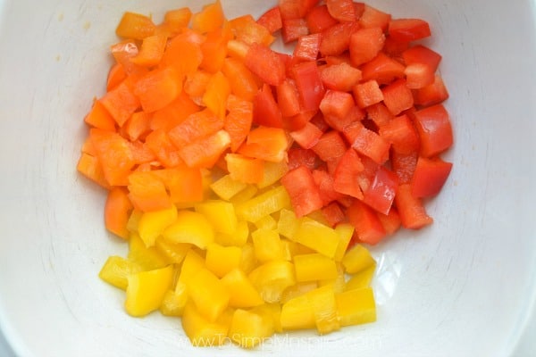 closeup of diced red, yellow and orange bell peppers