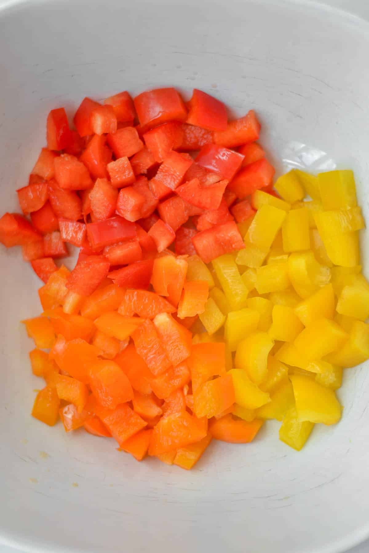 closeup of diced red, yellow and orange bell peppers