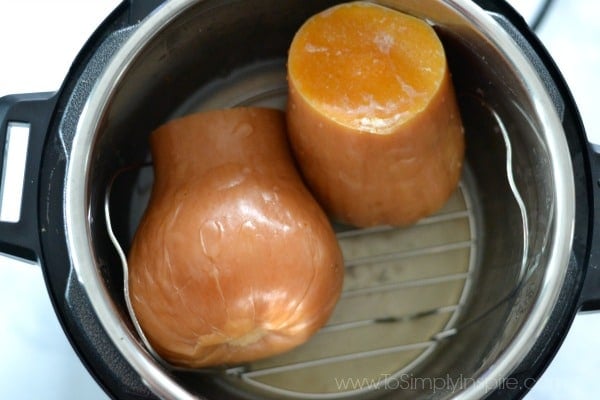 cooked halves of butternut squash inside an instant pot