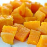 closeup of cooked butternut squash cut into cubes