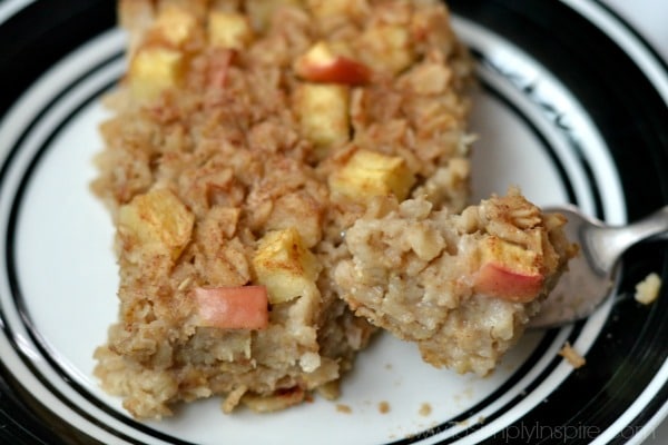 slice of apple cinnamon baked oatmeal on a plate with a bite on a fork