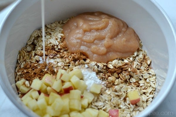 pouring milk over ingredients for baked oatmeal