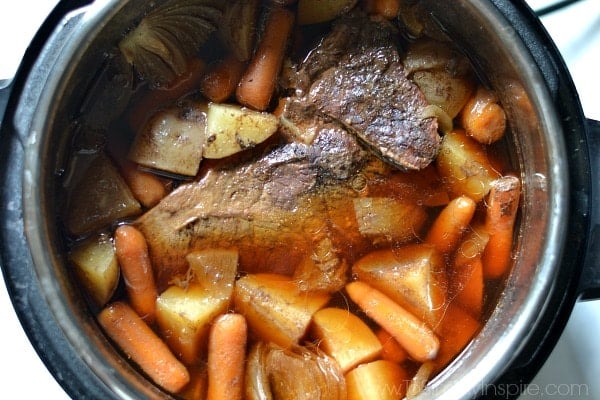 A instant pot filled with meat and vegetables, with Pot roast and Potato